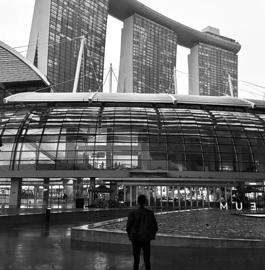 Furqan Sheikh standing in front of Marina Bay Sands in Singapore