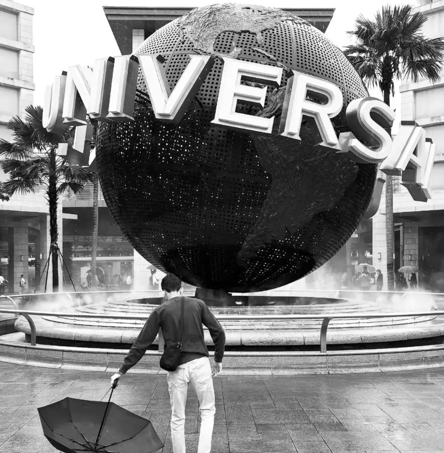 Furqan Sheikh walking past the Universal Studios globe in Singapore